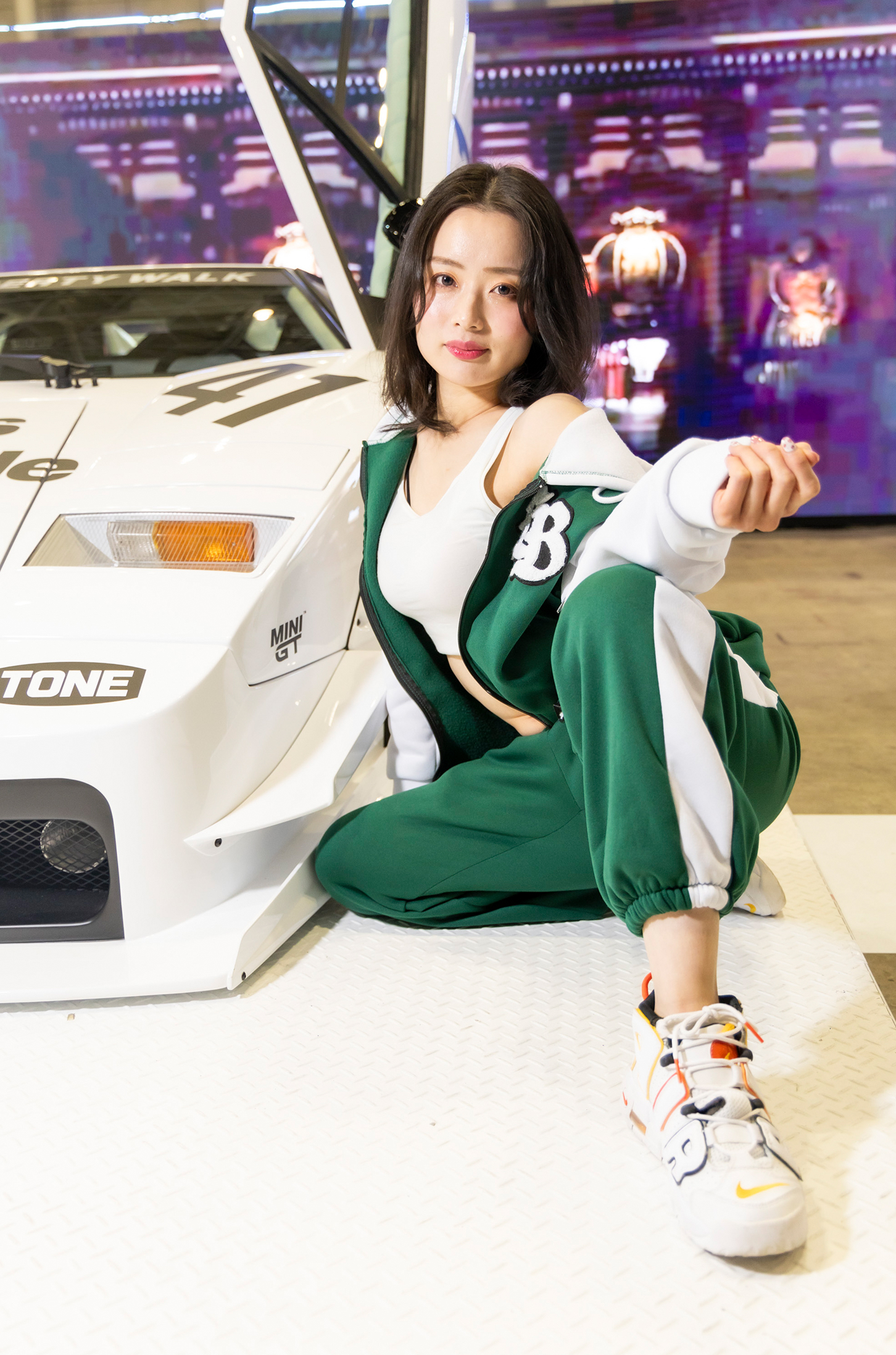 ランボルギーニ・カウンタックのカスタムカーの前で大胆なポーズを取る美女