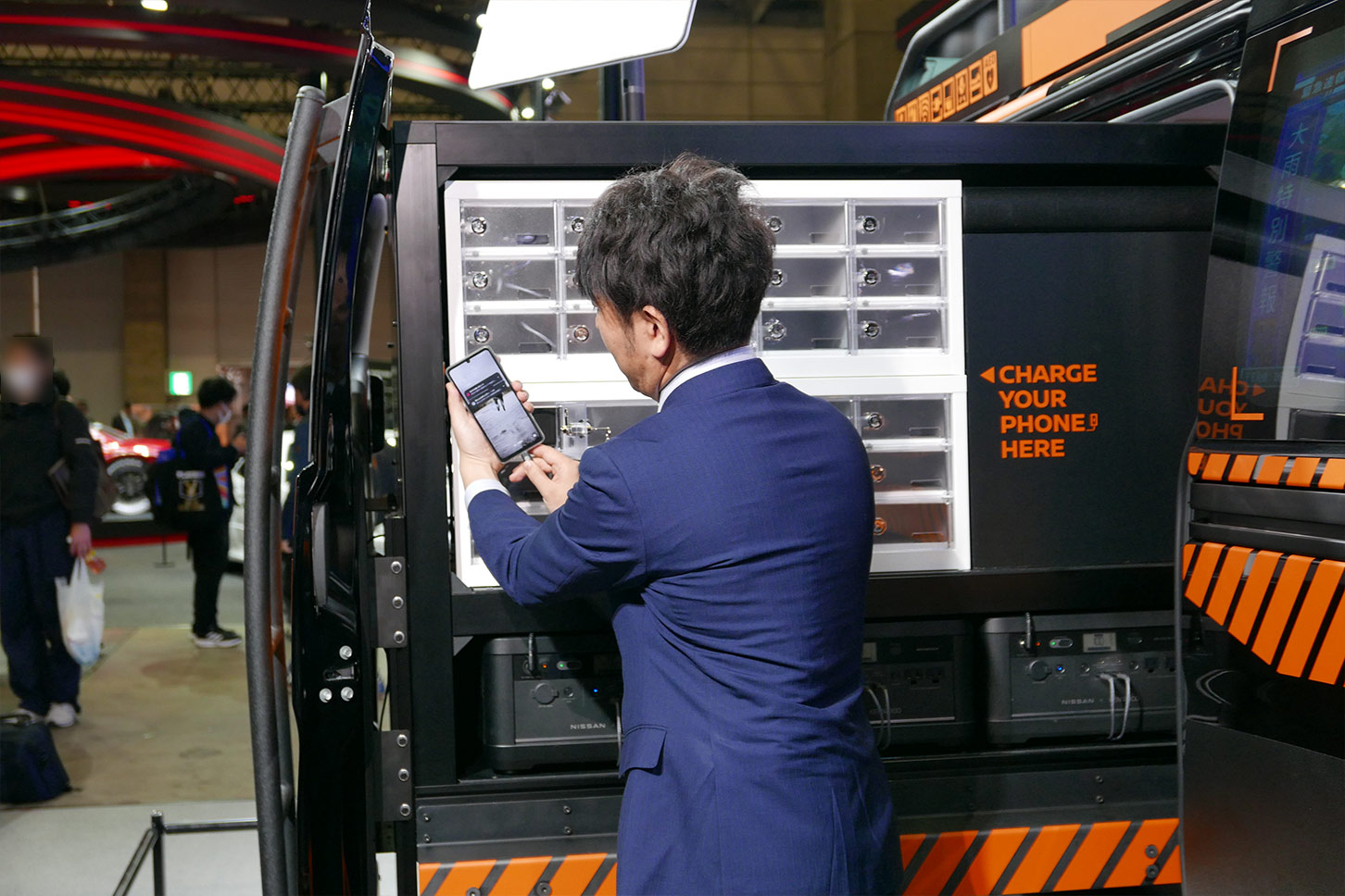 車体の左側に引き出した充電ボックスでスマホを充電している様子。