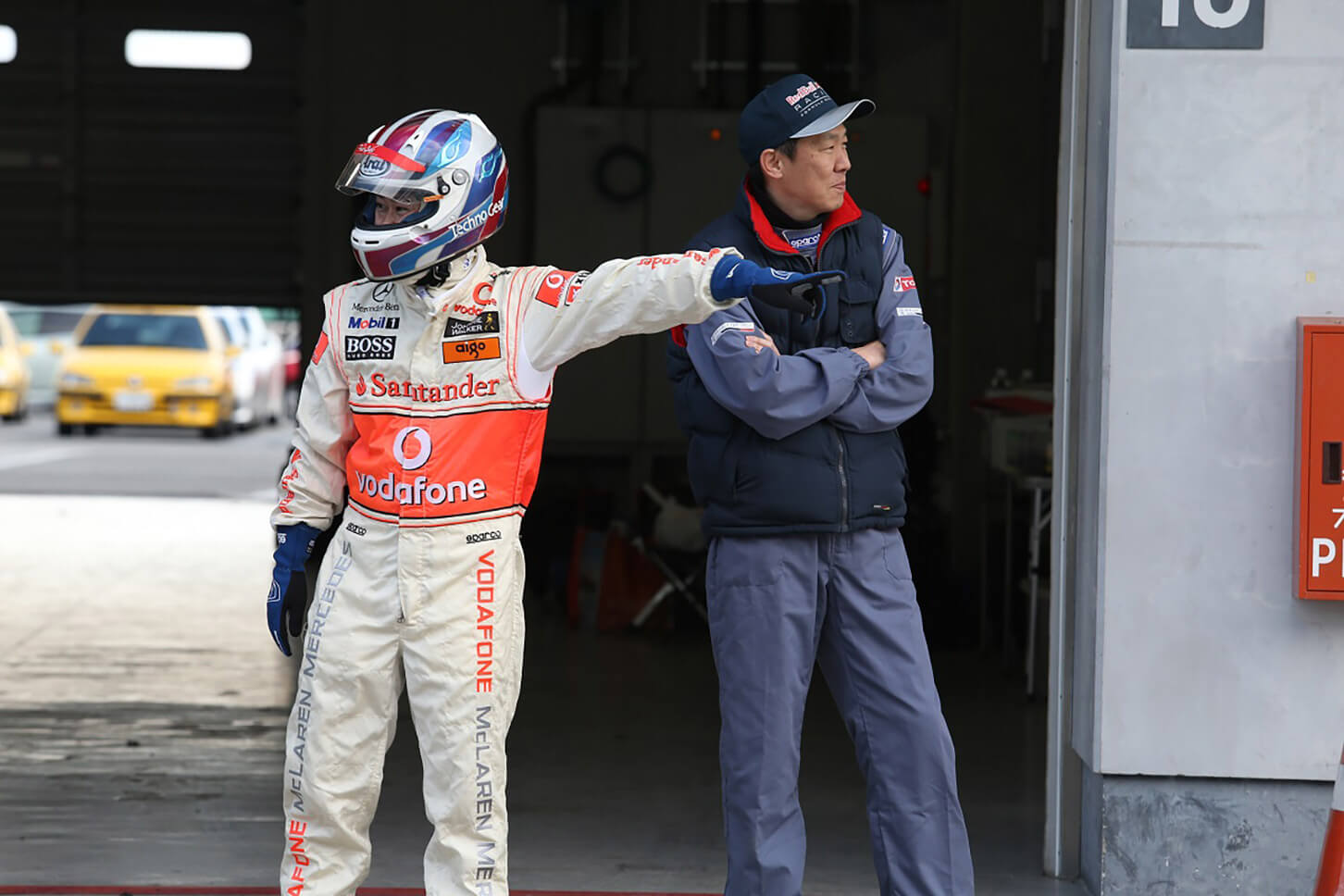 F1チームのレーシングスーツで運転する参加者